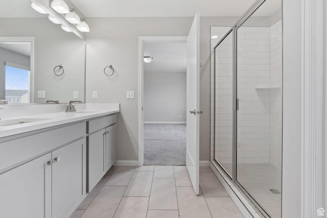 full bath with double vanity, a sink, tile patterned flooring, and a shower stall