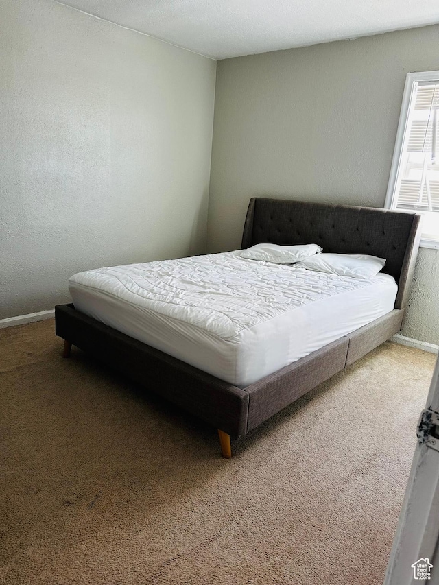 carpeted bedroom featuring baseboards