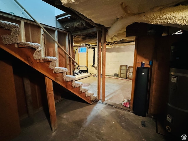 unfinished below grade area with water heater and stairway