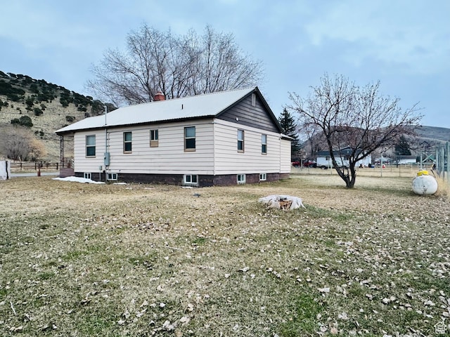 exterior space with fence and a mountain view