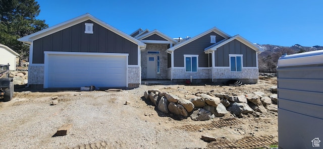 view of front of home featuring board and batten siding, driveway, and an attached garage