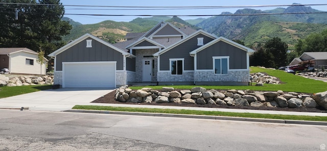 1870 N Valley View Dr Unit 201, Layton, UT 84040 - view of front of property featuring board and batten siding, a mountain view, and stone siding