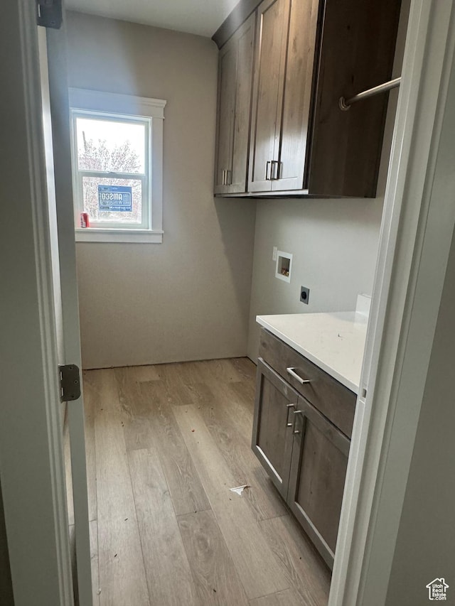 1870 N Valley View Dr Unit 201, Layton, UT 84040 - laundry area with electric dryer hookup, cabinet space, hookup for a washing machine, and light wood-style flooring
