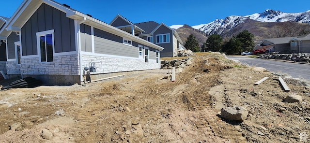 1870 N Valley View Dr Unit 201, Layton, UT 84040 - view of side of home with stone siding, board and batten siding, and a mountain view