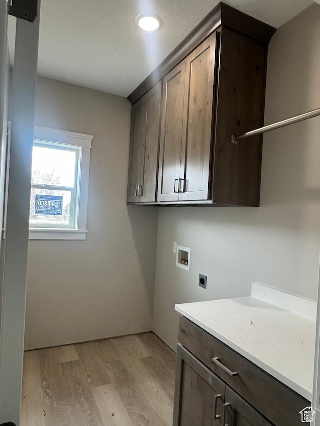 1870 N Valley View Dr Unit 201, Layton, UT 84040 - laundry area featuring electric dryer hookup, washer hookup, light wood-style floors, cabinet space, and recessed lighting