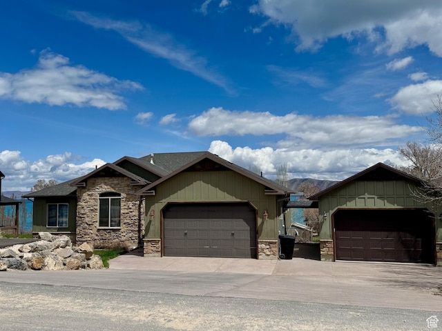 29 W Tamarind Way, Garden City, UT 84028 - view of front of house with concrete driveway, board and batten siding, stone siding, and a garage
