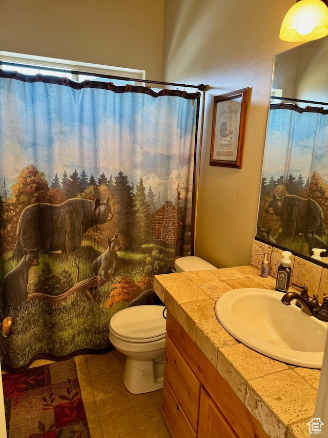 29 W Tamarind Way, Garden City, UT 84028 - full bathroom with toilet, a shower with curtain, tile patterned flooring, and vanity
