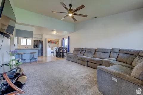 living area with carpet flooring and ceiling fan