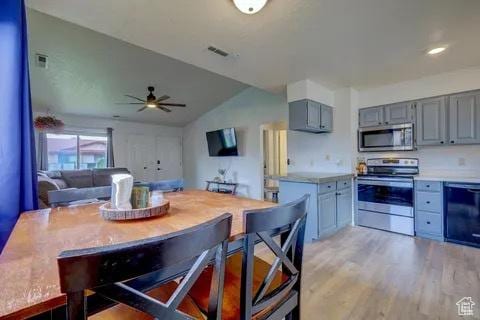 kitchen featuring light countertops, gray cabinets, light wood finished floors, and appliances with stainless steel finishes