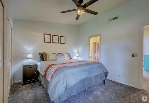 carpeted bedroom featuring baseboards, ceiling fan, and visible vents