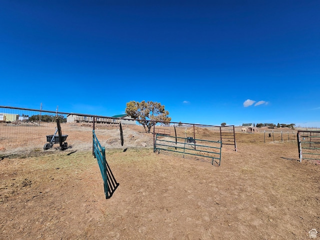surrounding community with fence and a rural view