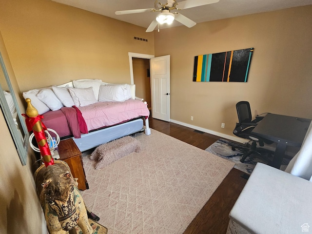 bedroom featuring a ceiling fan, wood finished floors, baseboards, and visible vents