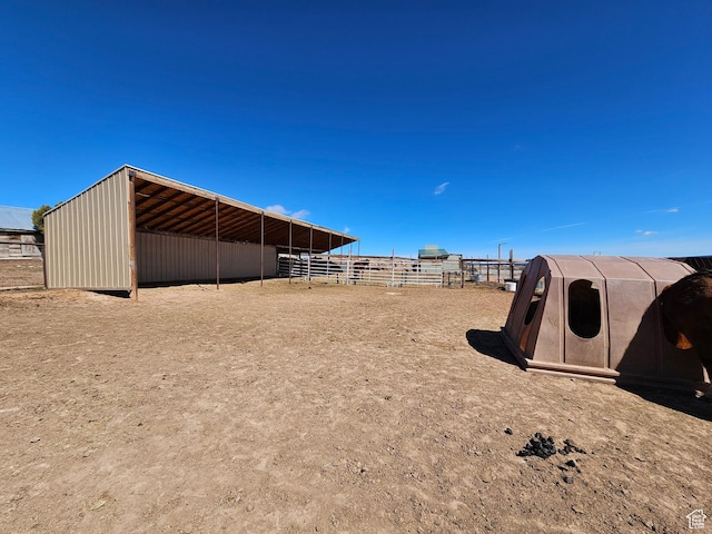 view of yard with an exterior structure, an outbuilding, and a carport