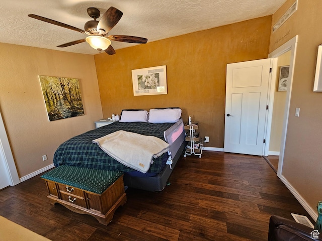 bedroom featuring baseboards, wood finished floors, ceiling fan, and a textured ceiling
