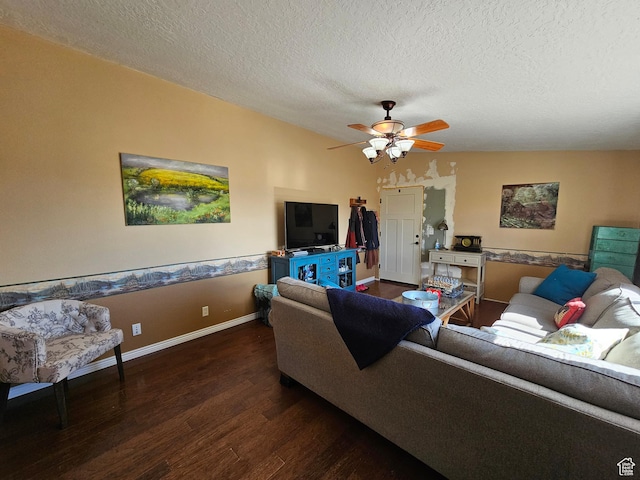 living area with a textured ceiling, baseboards, ceiling fan, and wood finished floors