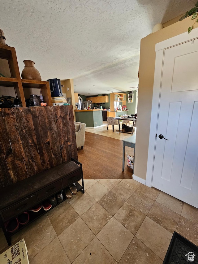 interior space with tile patterned flooring and a textured ceiling
