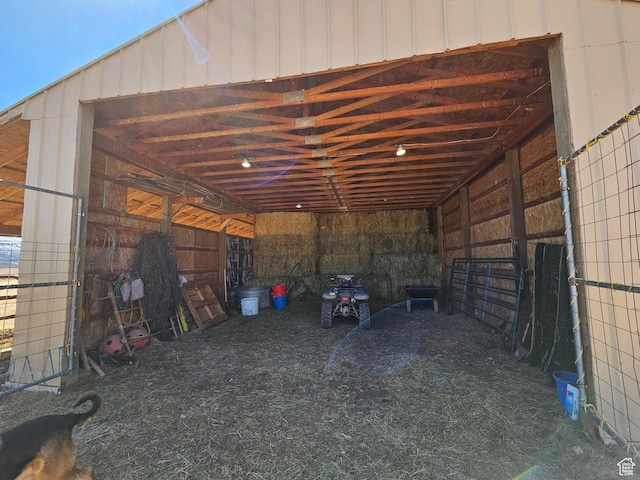 interior space featuring an attached carport and an exterior structure
