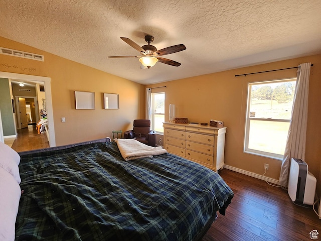 bedroom with visible vents, baseboards, ceiling fan, wood finished floors, and lofted ceiling