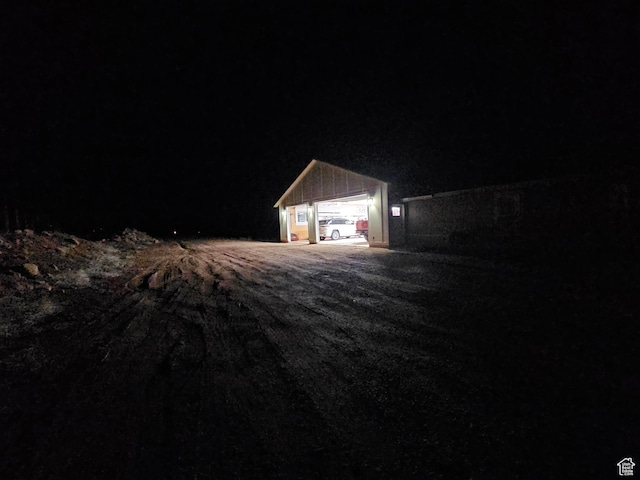 view of garage at twilight