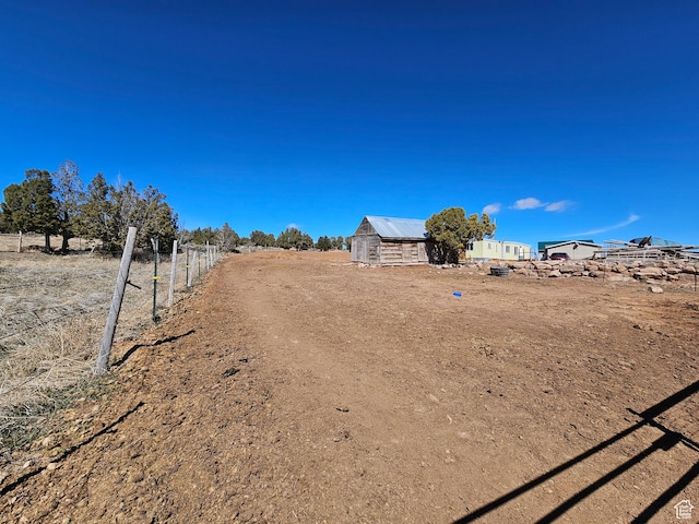view of yard with fence and an outdoor structure