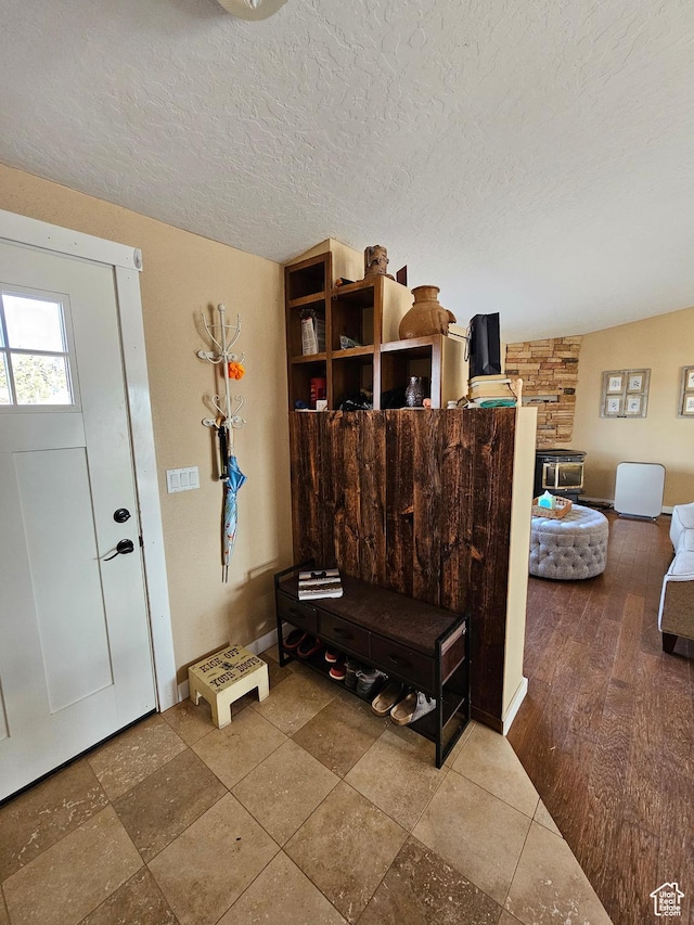 entryway featuring baseboards and a textured ceiling