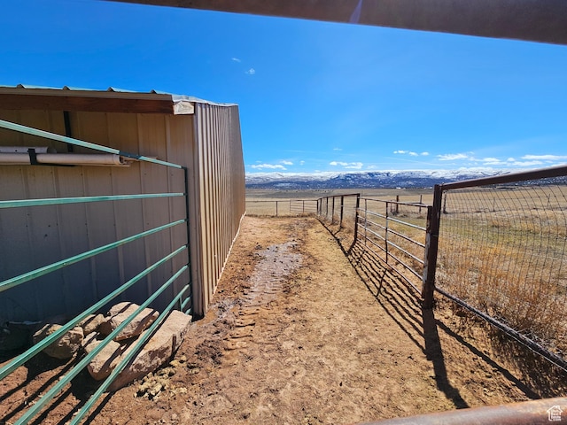 view of yard featuring fence and a rural view