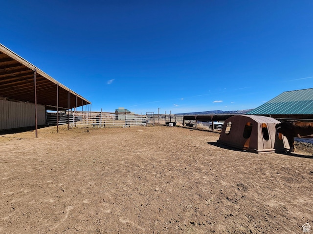 view of yard with an outbuilding, an exterior structure, and a carport