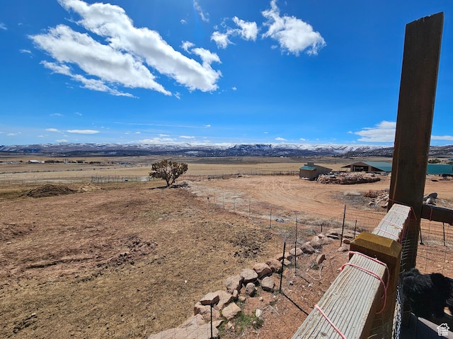 view of yard with a mountain view and a rural view