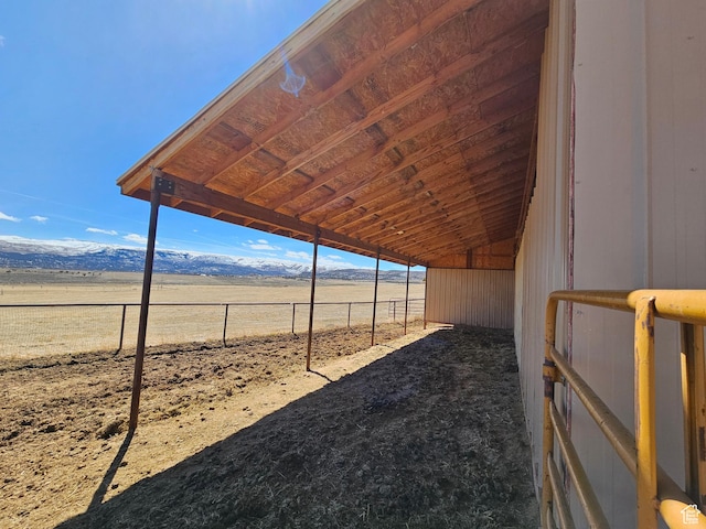view of yard with an exterior structure, an outdoor structure, a mountain view, and a rural view