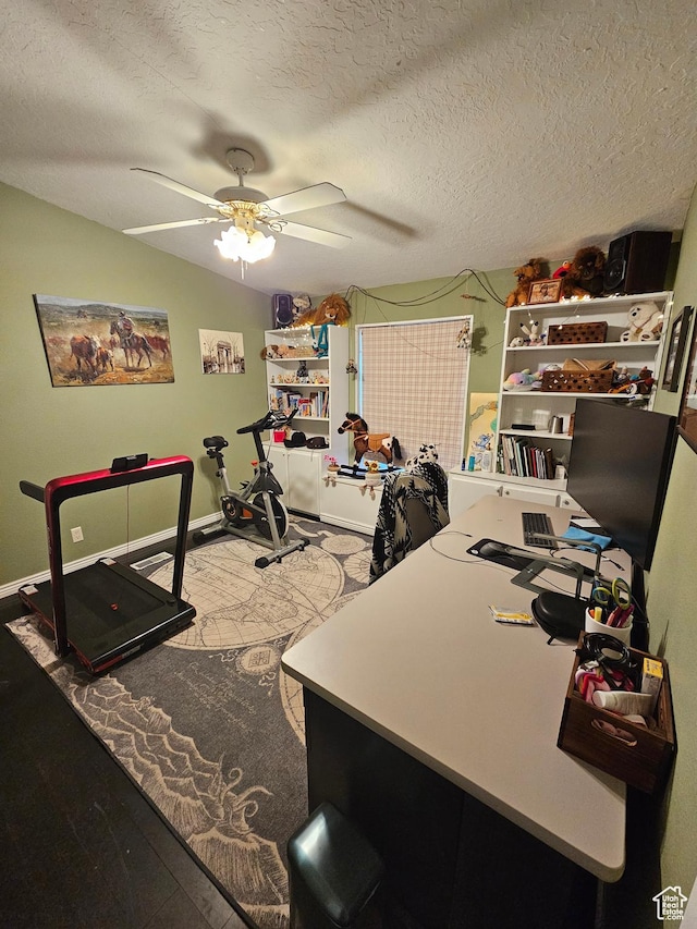 home office with a textured ceiling, baseboards, and ceiling fan