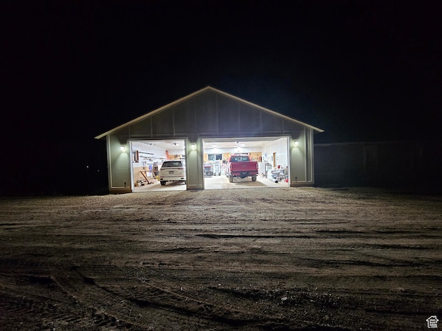 view of garage at twilight