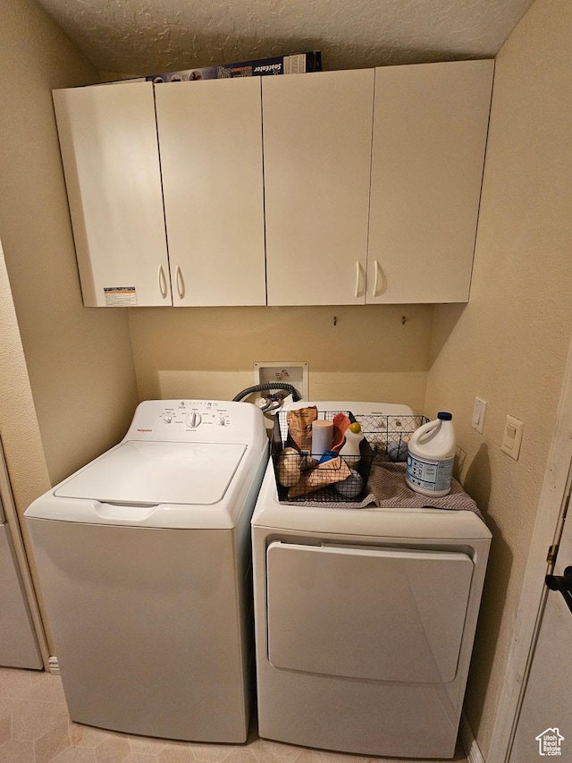 laundry room featuring cabinet space and washing machine and dryer