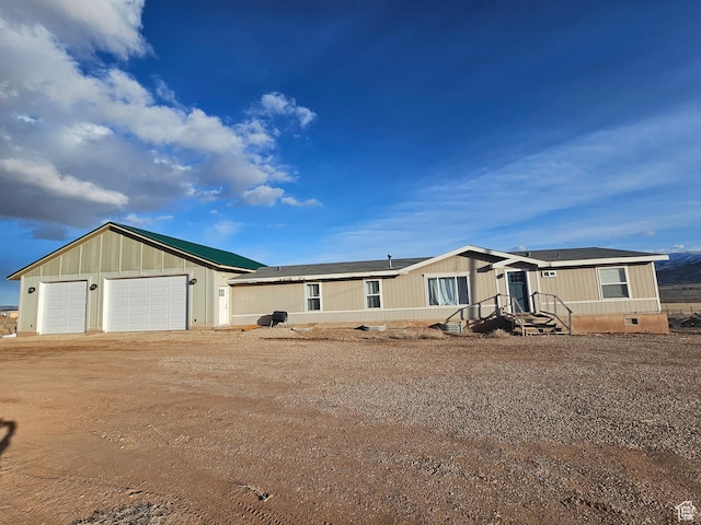 manufactured / mobile home featuring crawl space, a garage, and roof mounted solar panels