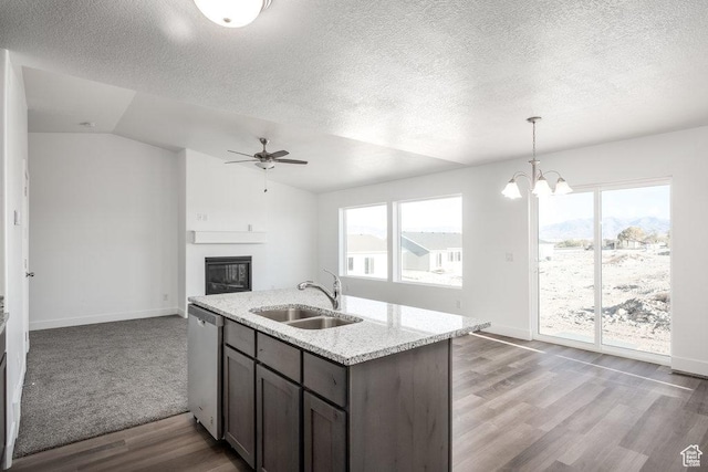 1167 W Rocky Way Unit 617, Grantsville, UT 84029 - kitchen with vaulted ceiling, a sink, a large fireplace, stainless steel dishwasher, and ceiling fan with notable chandelier