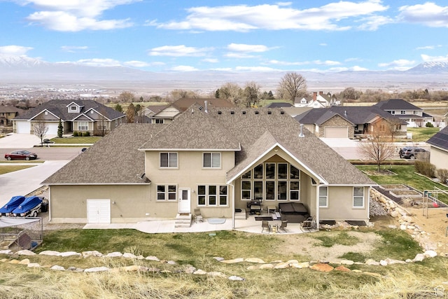 116 N 820 E, Hyde Park, UT 84318 - back of house featuring stucco siding, a patio, a residential view, entry steps, and a mountain view