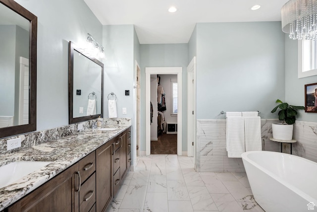 116 N 820 E, Hyde Park, UT 84318 - bathroom featuring a sink, a soaking tub, wainscoting, marble finish floor, and recessed lighting