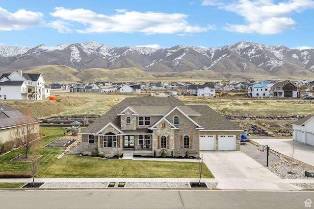 116 N 820 E, Hyde Park, UT 84318 - view of front of property featuring stone siding, driveway, a front yard, a mountain view, and a shingled roof