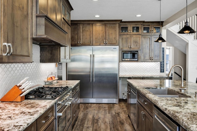 116 N 820 E, Hyde Park, UT 84318 - kitchen featuring dark wood-style flooring, glass insert cabinets, a sink, light stone counters, and built in appliances