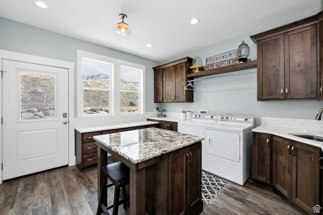 116 N 820 E, Hyde Park, UT 84318 - washroom featuring washing machine and clothes dryer, cabinet space, a sink, and dark wood-style flooring