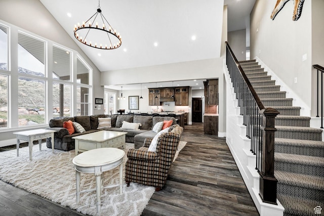 116 N 820 E, Hyde Park, UT 84318 - living area with dark wood finished floors, high vaulted ceiling, stairway, and an inviting chandelier