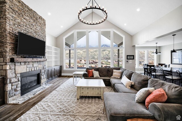 116 N 820 E, Hyde Park, UT 84318 - living area with recessed lighting, high vaulted ceiling, a notable chandelier, a fireplace, and wood finished floors