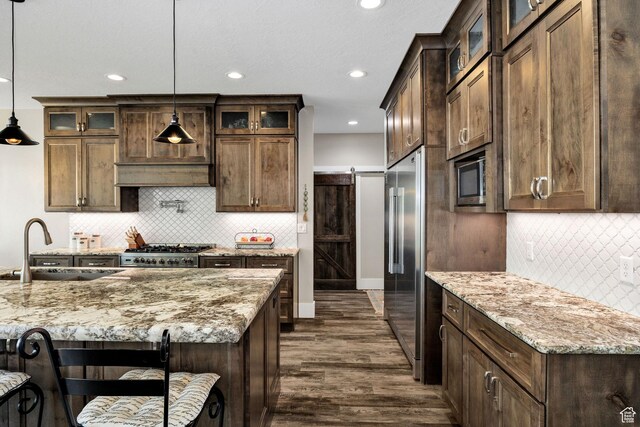 116 N 820 E, Hyde Park, UT 84318 - kitchen featuring a sink, appliances with stainless steel finishes, light stone counters, and pendant lighting