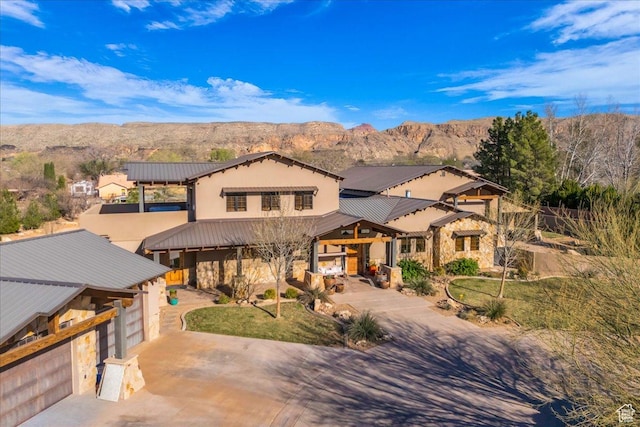 580 S 920 W, Hurricane, UT 84737 - view of front of house with driveway, metal roof, a mountain view, and stone siding