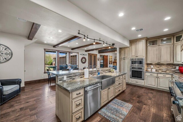 580 S 920 W, Hurricane, UT 84737 - kitchen featuring a sink, backsplash, appliances with stainless steel finishes, a center island with sink, and cream cabinets