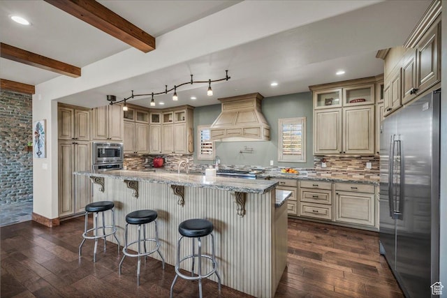 580 S 920 W, Hurricane, UT 84737 - kitchen featuring custom range hood, dark wood-style flooring, backsplash, beam ceiling, and appliances with stainless steel finishes