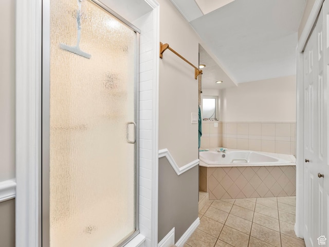 bathroom with a shower stall, tile patterned floors, and a garden tub