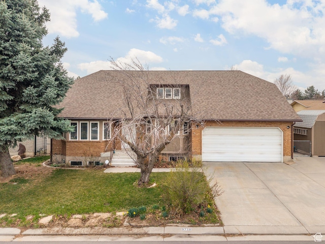 view of front facade with a front lawn, driveway, a garage, and brick siding
