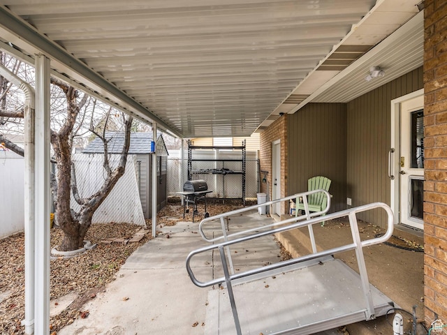 view of patio with a grill and fence