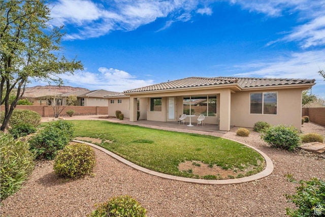 875 E Roadrunner Dr, Washington, UT 84780 - rear view of property with a tiled roof, a lawn, stucco siding, fence private yard, and a patio area