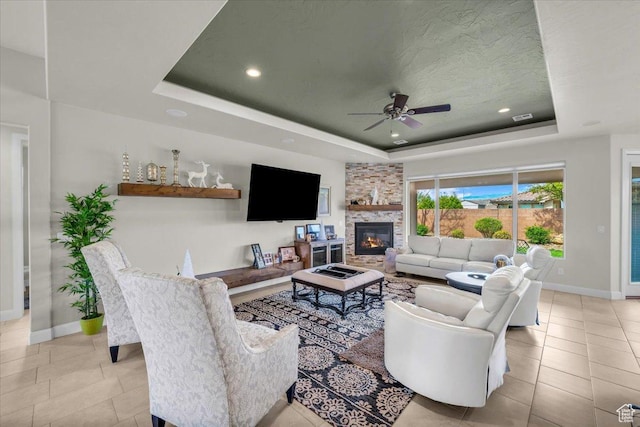 875 E Roadrunner Dr, Washington, UT 84780 - tiled living room with a tray ceiling, baseboards, a fireplace, and ceiling fan
